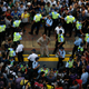 An injured man is separated from the crowd by police in Mong Kok.